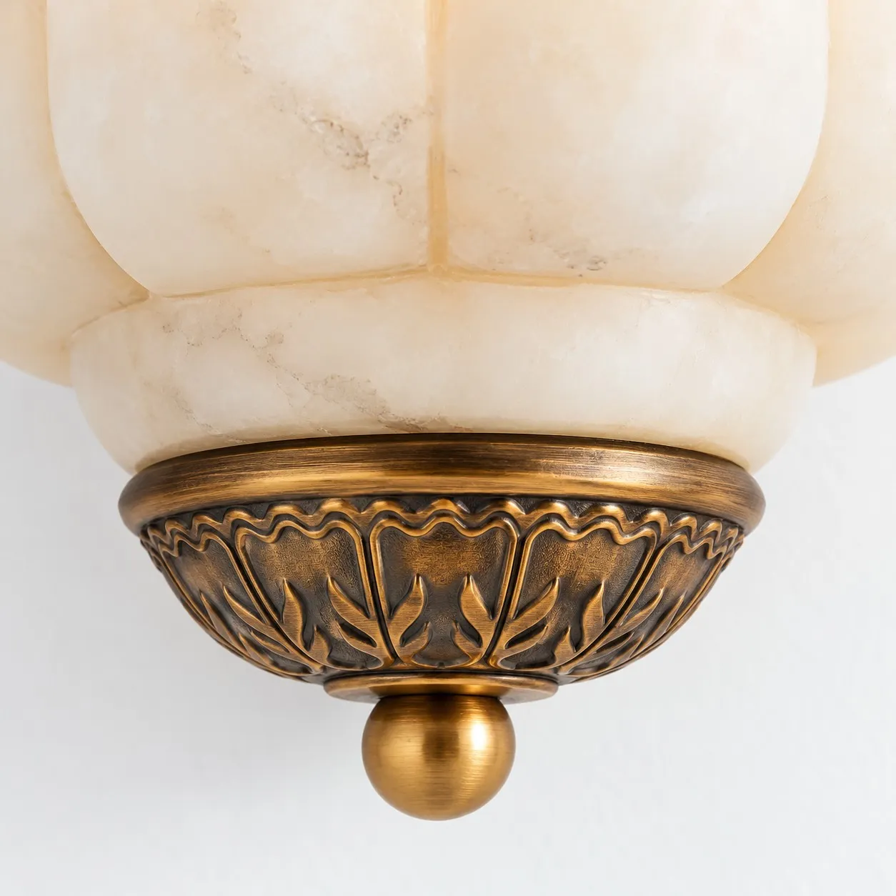 Carved ornamental metal cap and round finial