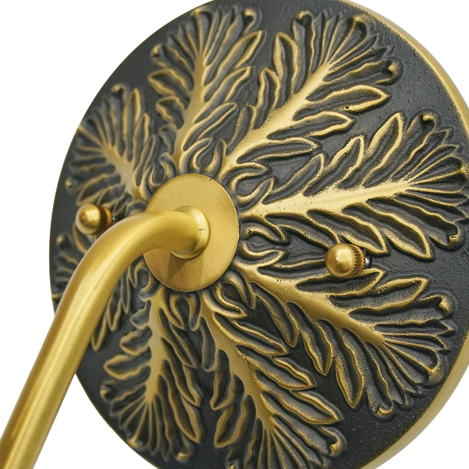 Sculpted leaf-pattern backplate and curved arm connection