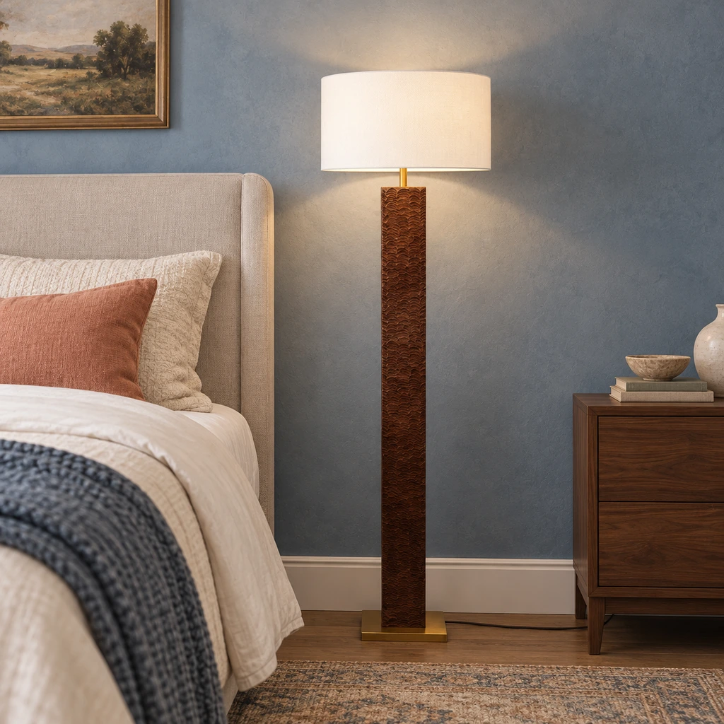 Nora floor lamp beside an upholstered bed